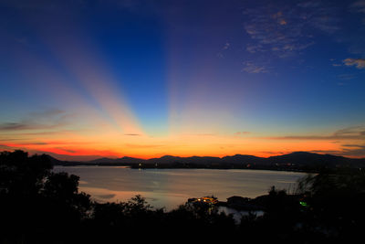 Scenic view of lake against orange sky