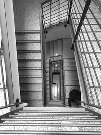 High angle view of man walking on spiral staircase