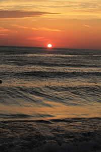 Scenic view of sea against romantic sky at sunset