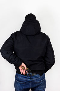 Rear view of man standing against white background