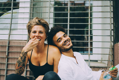 Portrait of smiling young man sitting outdoors