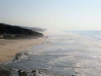 Scenic view of beach against clear sky