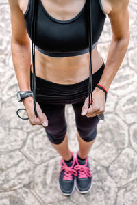 Midsection of woman standing against blurred background