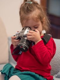 Young woman photographing with camera