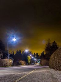 View of illuminated street lights at night
