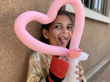 Portrait of smiling girl holding ballon