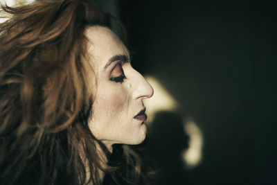 Close-up portrait of young woman looking away