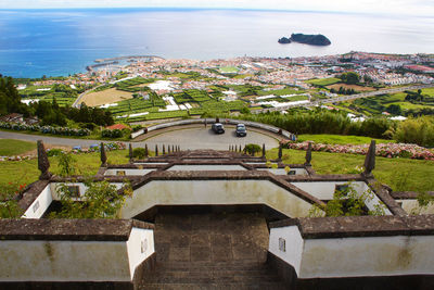 High angle view of townscape by sea against sky