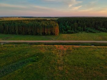 Scenic view of field against sky during sunset