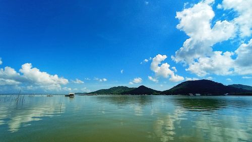 Scenic view of sea against blue sky