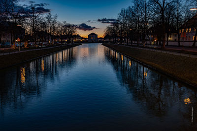 Scenic view of river against sky at sunset