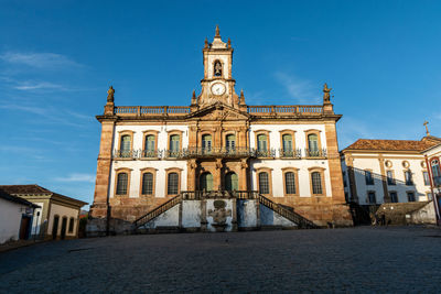 Facade of historic building against blue sky