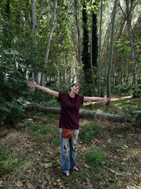 Full length of man standing by tree in forest