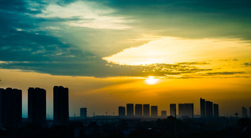 Scenic view of sunset over city