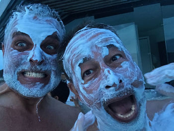 Portrait of funny friends with facial mask outdoors