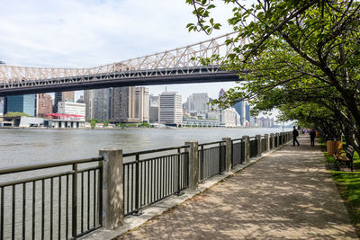 Footpath amidst buildings against sky