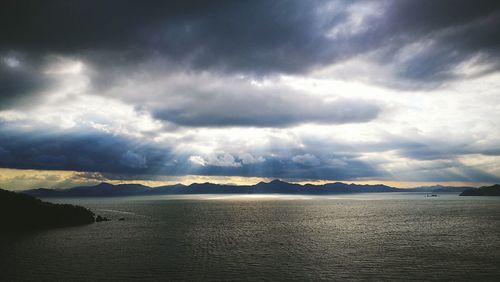 Scenic view of sea against storm clouds