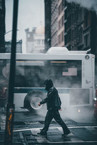 Full length of man standing on street in city