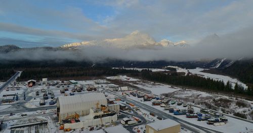 High angle view of cars on snowcapped mountains against sky