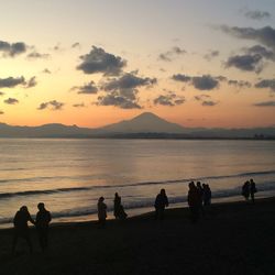 Silhouette of people at beach during sunset