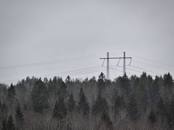 Low angle view of electricity pylon against sky