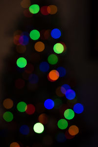 Defocused image of illuminated christmas tree at night