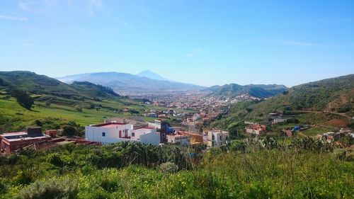 Scenic view of mountains against blue sky