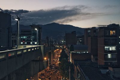 High angle view of illuminated cityscape against sky at night