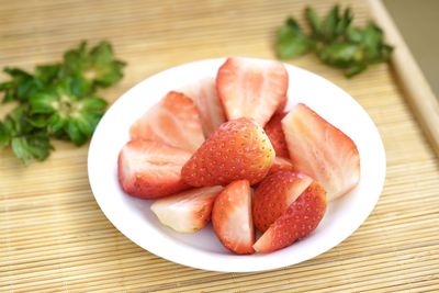 High angle view of strawberries in plate on table