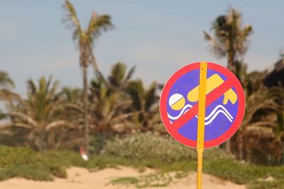 Close-up of no swimming sign at north beach against sky