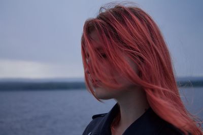 Young woman with redhead at sea