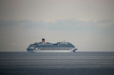 Ship sailing on sea against sky