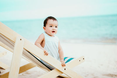 Close-up of baby sitting on beach