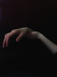 Close-up of hands over black background