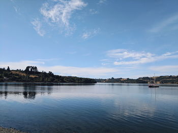 View of river by buildings against sky