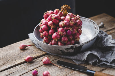 Close-up of onions in container on table