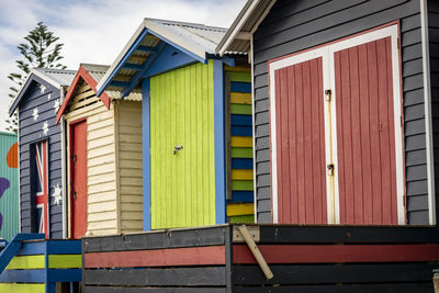 Multi colored houses in building against sky