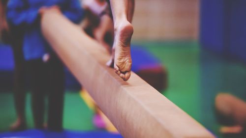 Low section of woman running on wood