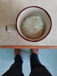 Low section of man holding food on table