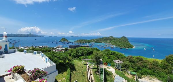 High angle view of townscape by sea against sky