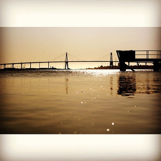 water, built structure, architecture, connection, bridge - man made structure, reflection, transfer print, waterfront, auto post production filter, clear sky, pier, sea, bridge, sky, wet, railing, long, outdoors, dusk, nature