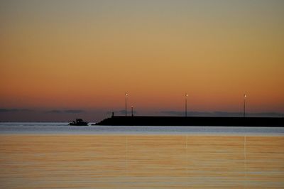 Scenic view of sea against clear sky during sunset