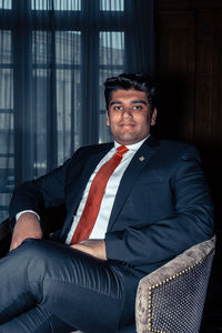 Portrait of young businessman sitting at home