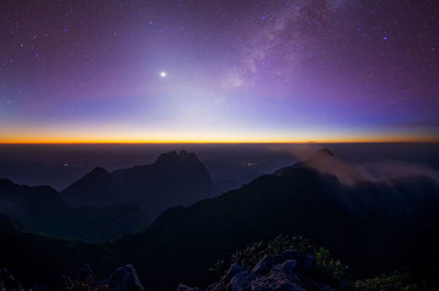 Scenic view of mountains against sky at night