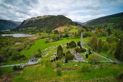 Aerial view of  medieval monastery ruins in glendalough with lower lake, hills and woodlands 
