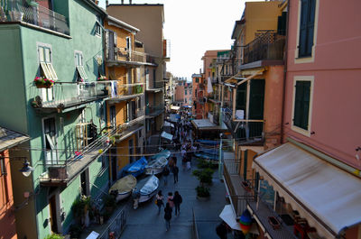 People on street amidst buildings in city