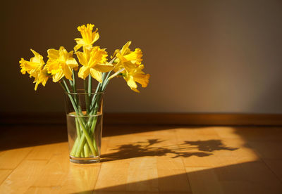 Close-up of yellow flowers on table