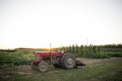 Tractor on field against clear sky