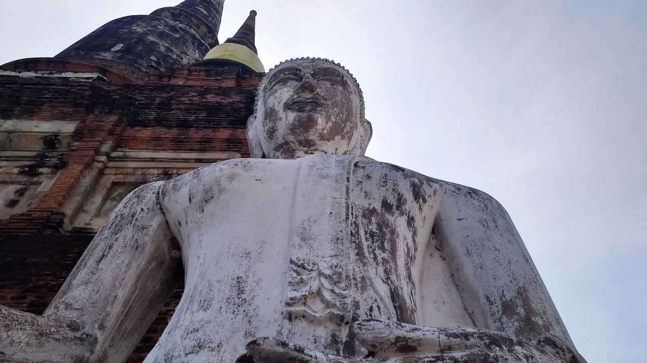 LOW ANGLE VIEW OF A STATUE OF A TEMPLE