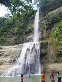 Scenic view of waterfall against trees